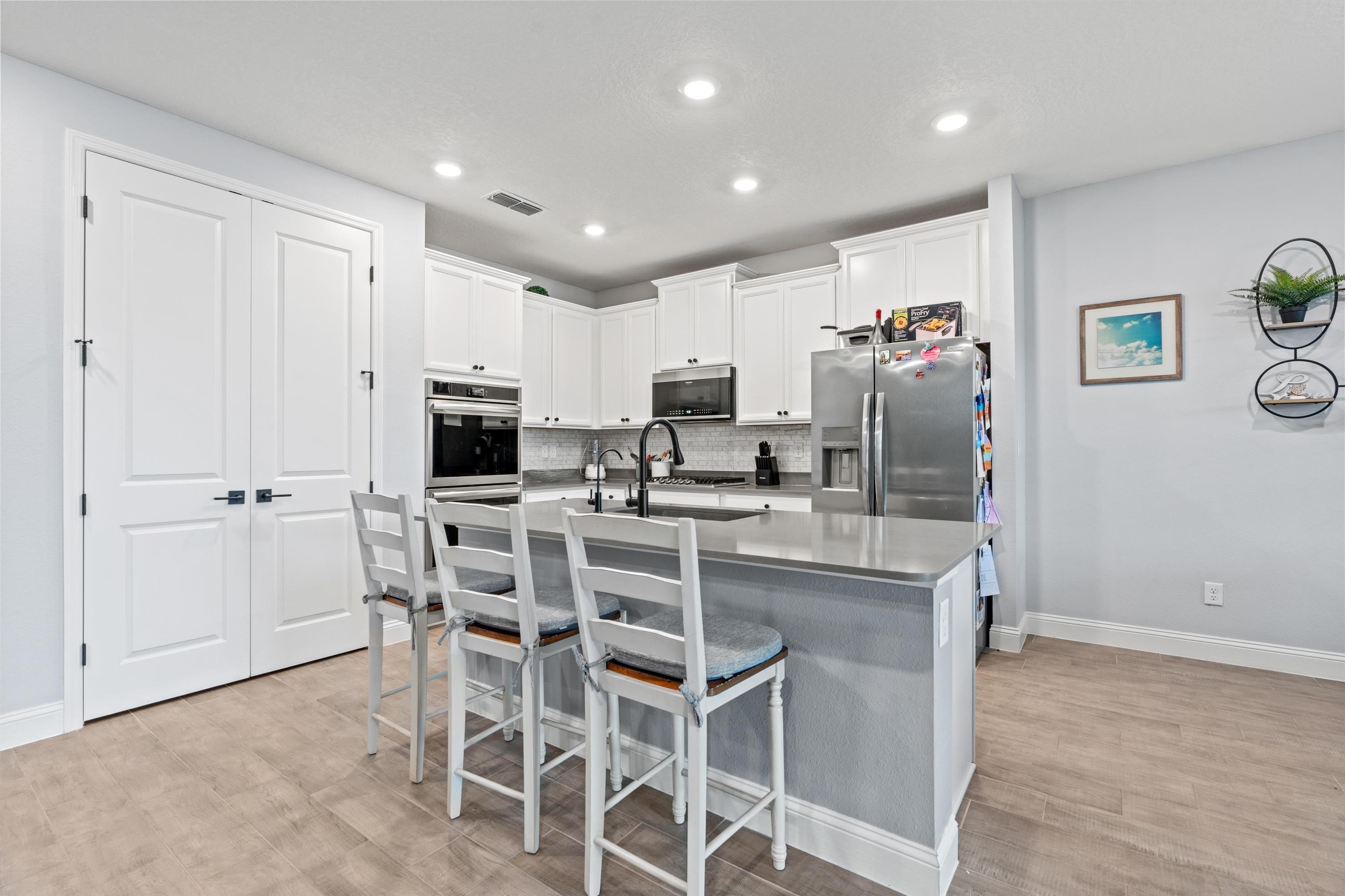 366 Varner Way St. Augustine, FL 32092 - Photo 12 of 50 a kitchen with kitchen island cabinets and refrigerator