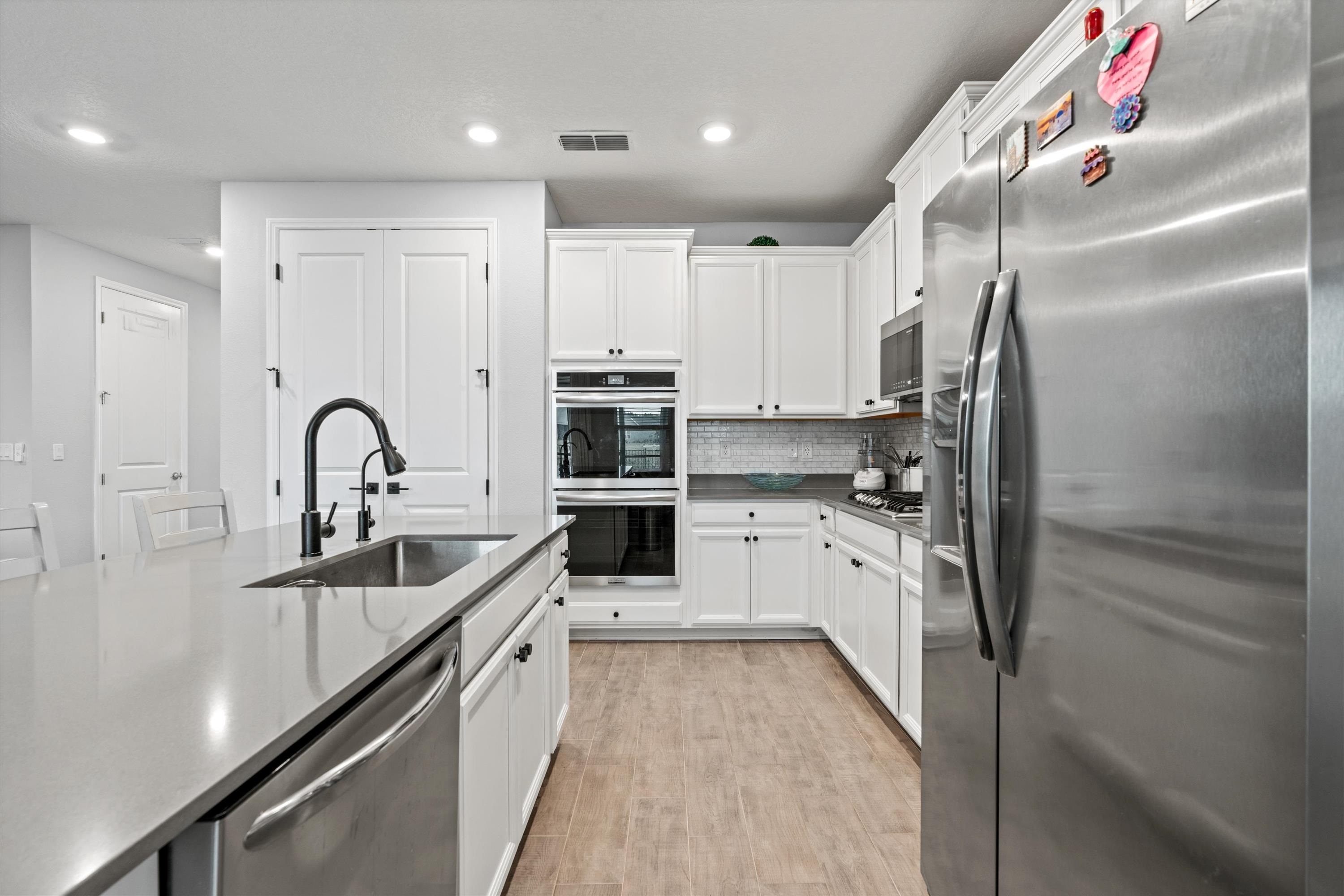 366 Varner Way St. Augustine, FL 32092 - Photo 13 of 50 a kitchen with white cabinets and stainless steel appliances