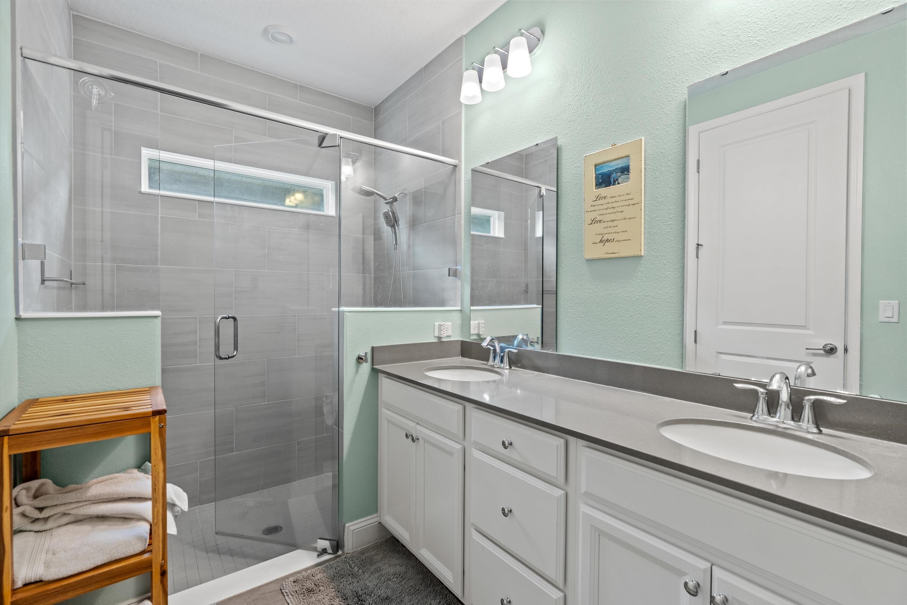 366 Varner Way St. Augustine, FL 32092 - Photo 18 of 50 a bathroom with a granite countertop sink a mirror and a shower