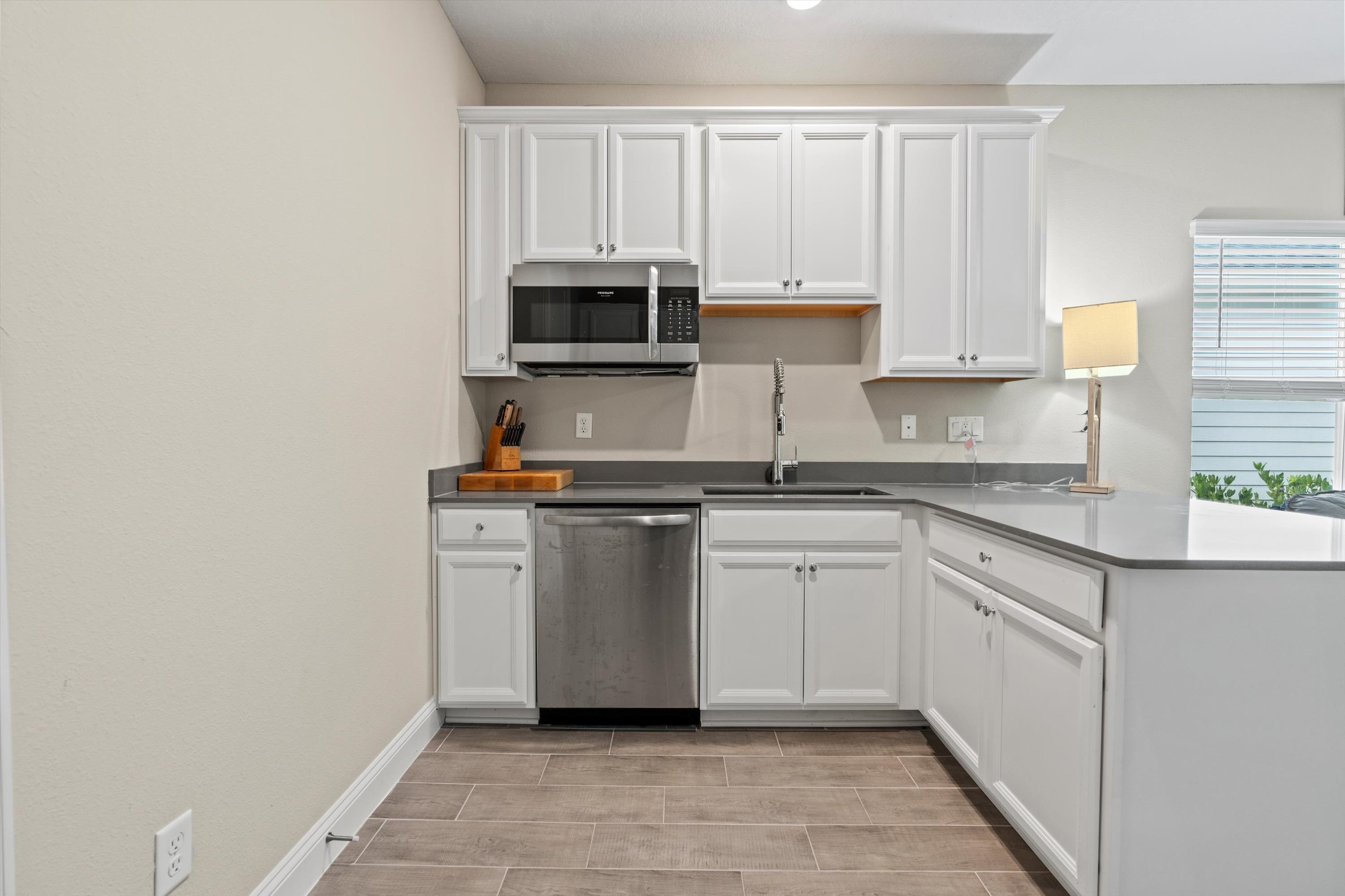 366 Varner Way St. Augustine, FL 32092 - Photo 23 of 50 a kitchen with stainless steel appliances granite countertop a stove a sink and white cabinets