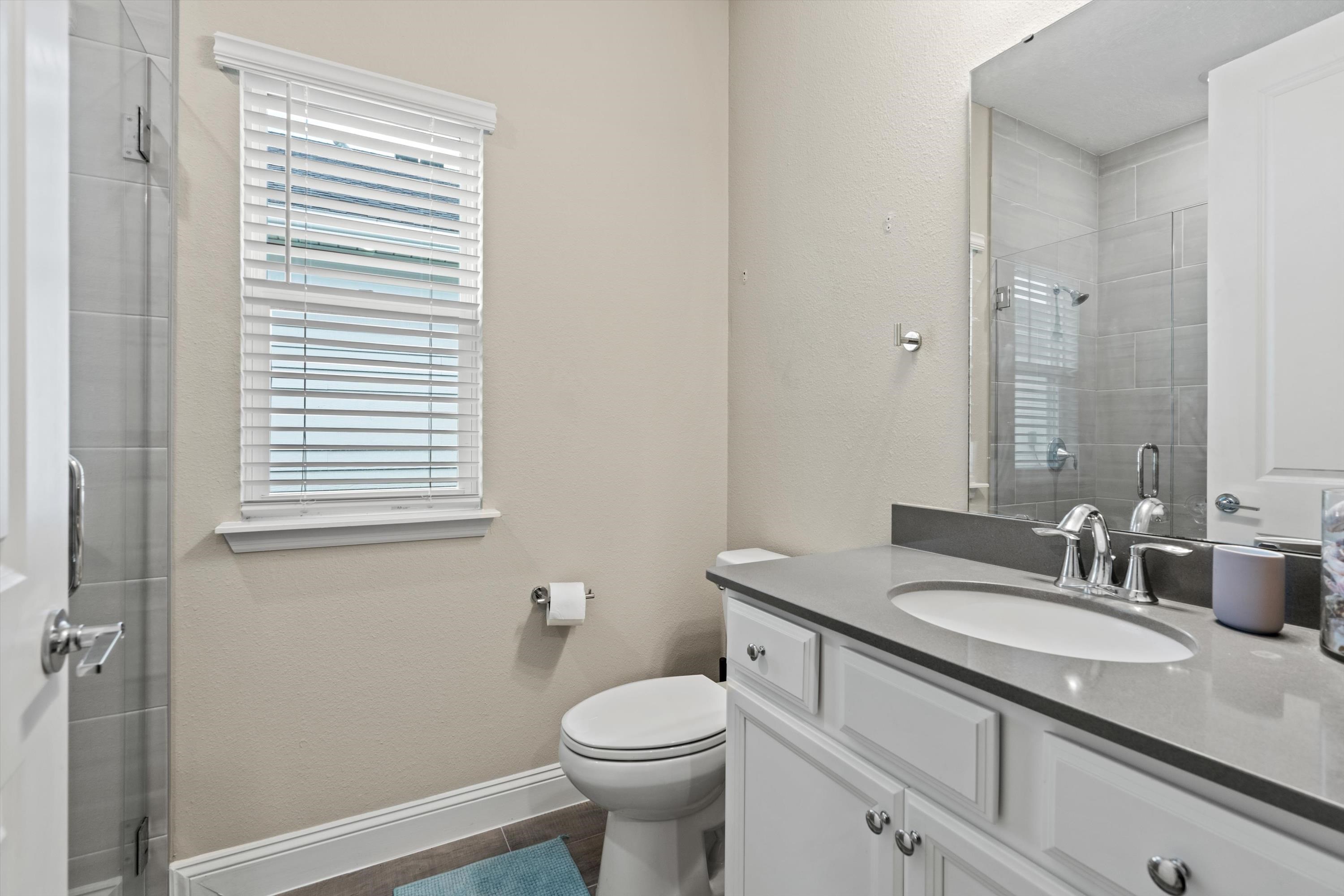 366 Varner Way St. Augustine, FL 32092 - Photo 27 of 50 a bathroom with a granite countertop toilet sink and mirror