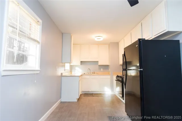 a kitchen with a refrigerator and a sink