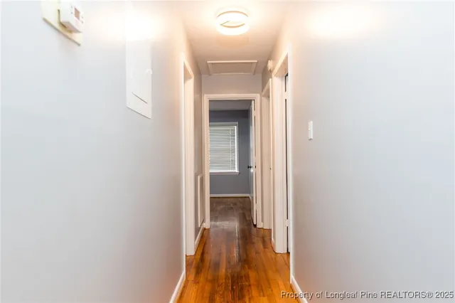 a view of a hallway with wooden floor