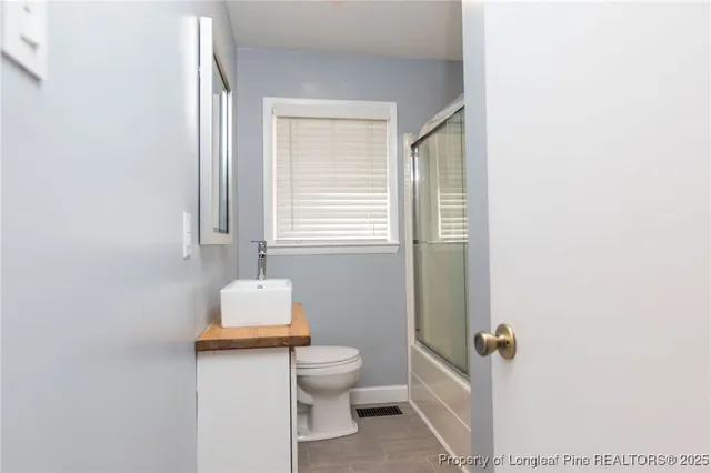 a bathroom with a toilet sink and a mirror