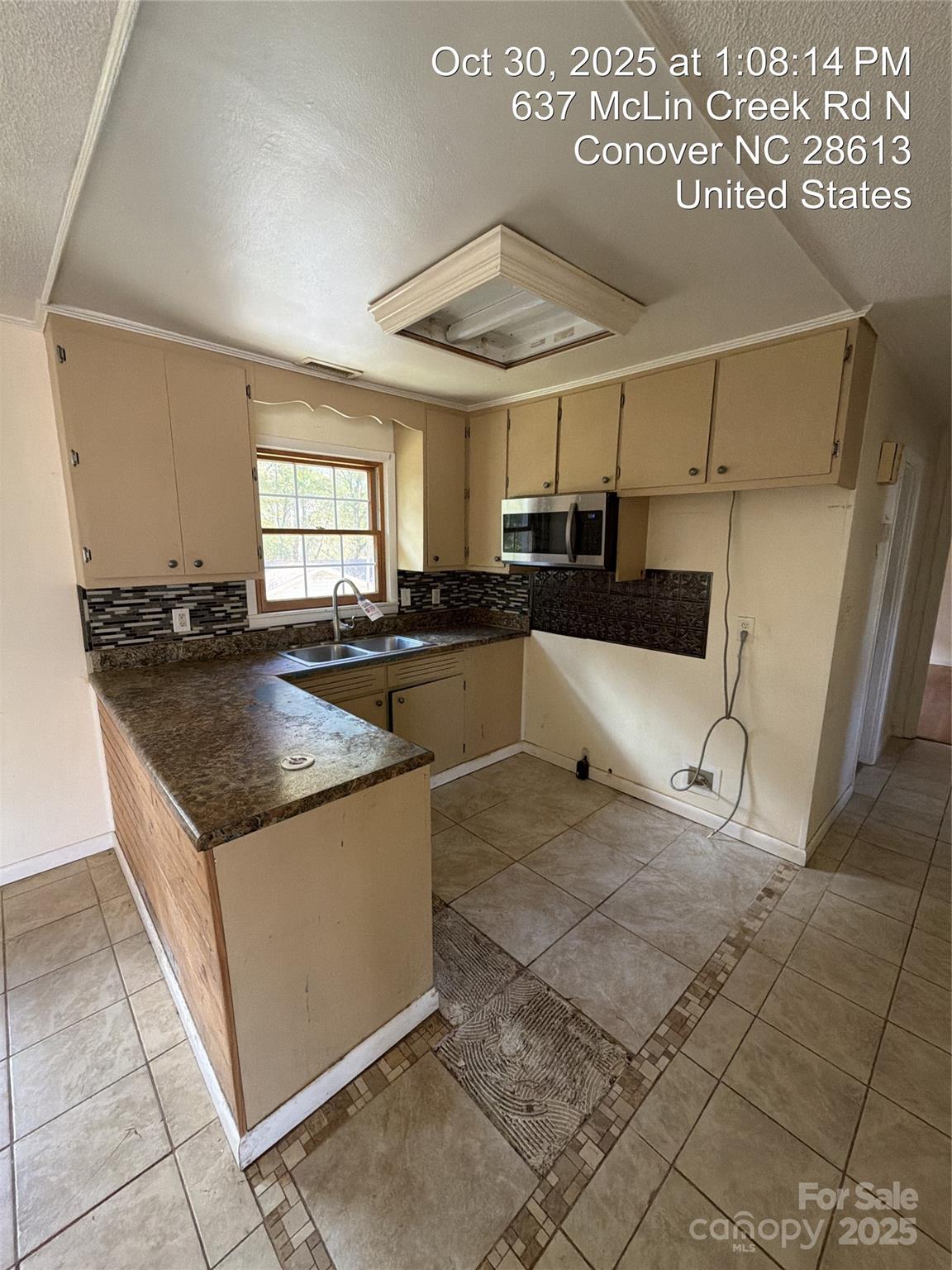 637 McLin Creek Road North Conover, NC 28613 - Photo 7 of 13 a kitchen with a stove a sink and a refrigerator