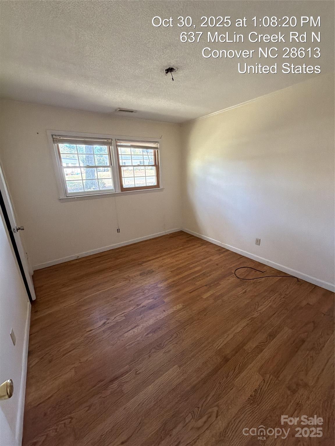 637 McLin Creek Road North Conover, NC 28613 - Photo 8 of 13 an empty room with wooden floor and windows