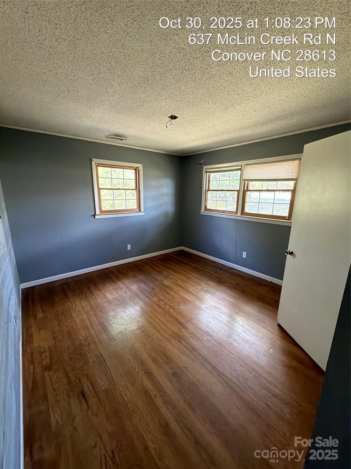 637 McLin Creek Road North Conover, NC 28613 - Photo 9 of 13 an empty room with wooden floor and windows