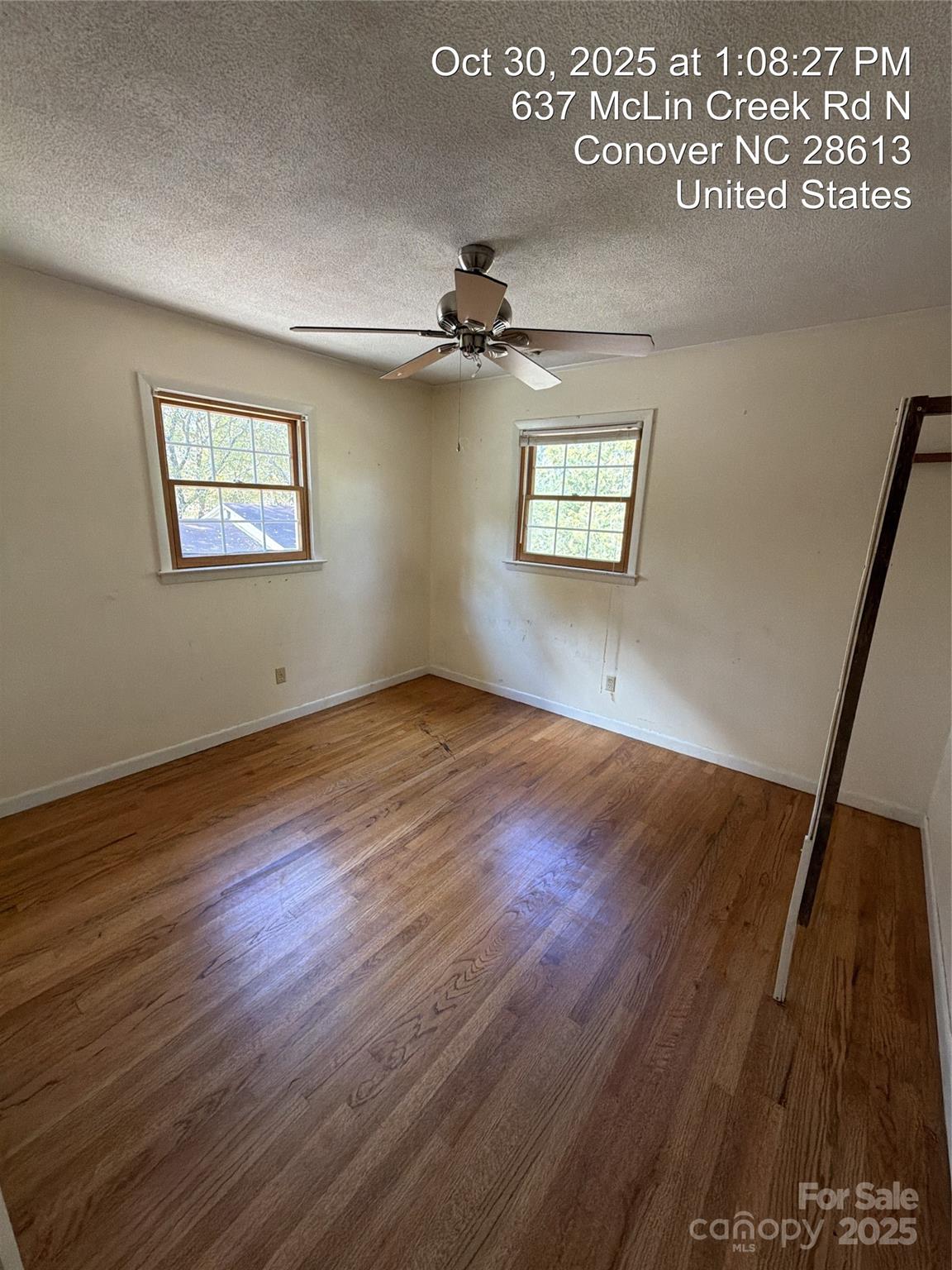 637 McLin Creek Road North Conover, NC 28613 - Photo 10 of 13 a view of an empty room with wooden floor and a ceiling fan