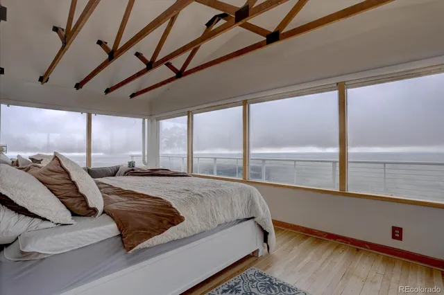 a bed sitting in a bedroom next to a window