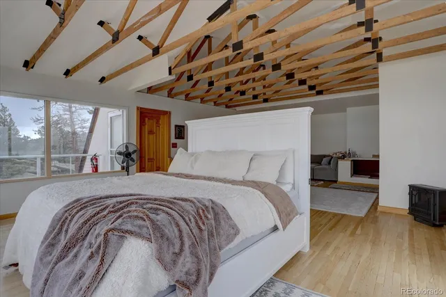 a large bed sitting in a bedroom next to a window