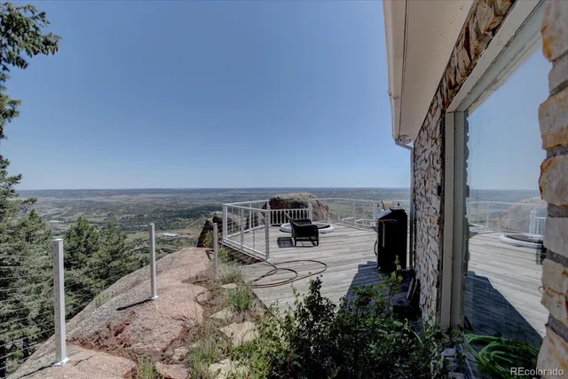 a view of a terrace with a bench and floor to ceiling window