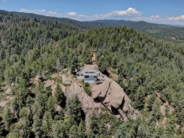 a view of a lush green hillside and a houses