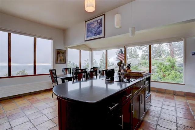 a kitchen with stainless steel appliances granite countertop a sink and a table