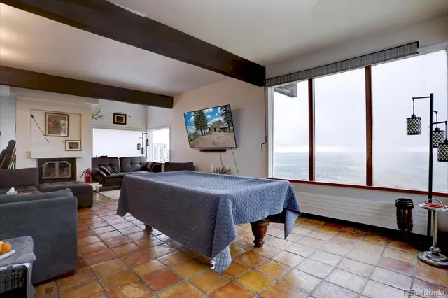 a bedroom with furniture and a large window