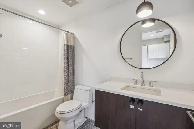 a bathroom with a sink toilet and a mirror