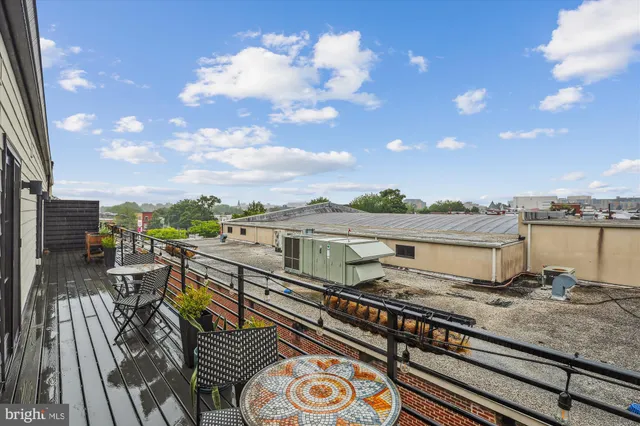 a view of a balcony with wooden benches