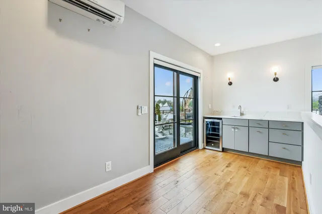 a view of a kitchen with refrigerator and sink
