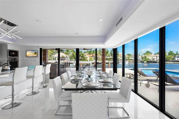 a living room with furniture and floor to ceiling windows
