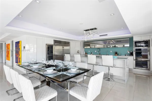 a view of a living room with a floor to ceiling window and wooden floor
