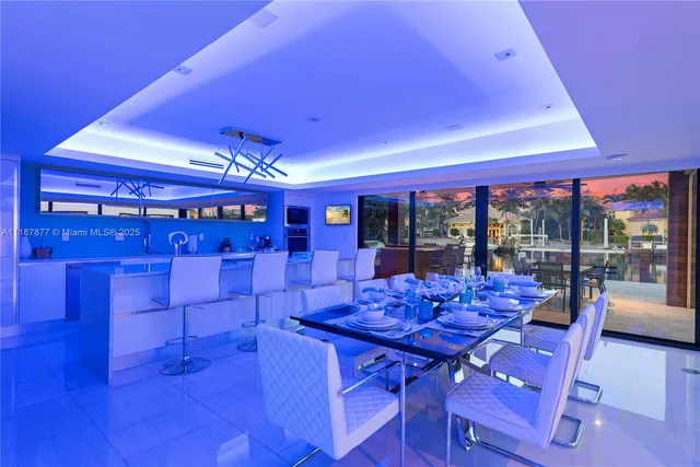 a view of a living room with a floor to ceiling window and wooden floor