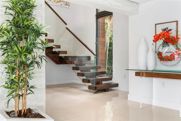 a white bed sitting in a room next to a window