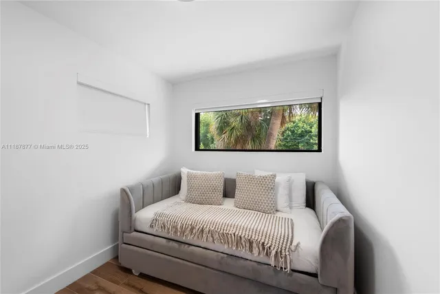 a bedroom with a balcony a bed and a window