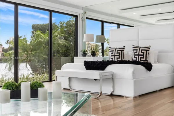 a bedroom with a bed and a lamp on dresser