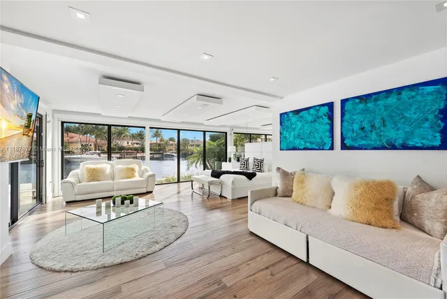 a bedroom with two beds and a flat screen tv