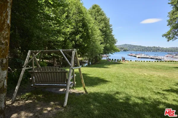 an aerial view of a house with a yard and lake view