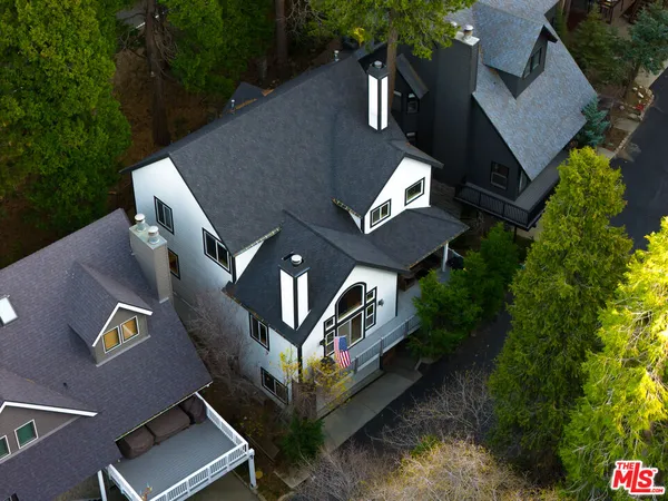 an aerial view of a house with a yard