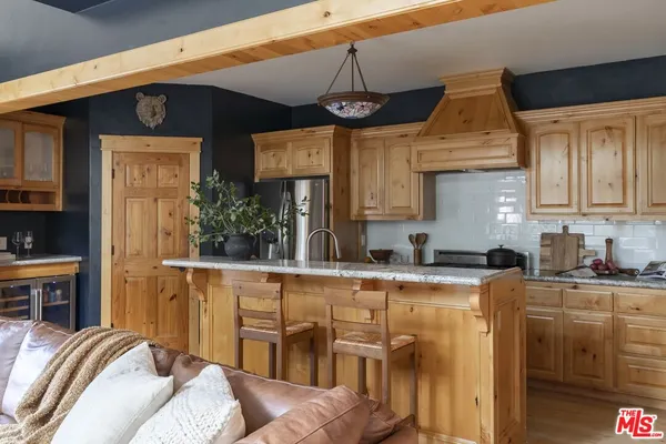 a kitchen with stainless steel appliances granite countertop a sink and cabinets