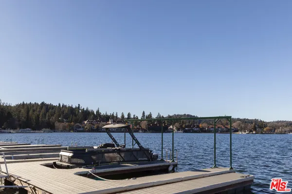 a view of a roof deck with lake and mountain view