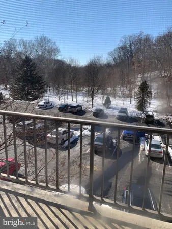 a view of a street with a car parked on the road