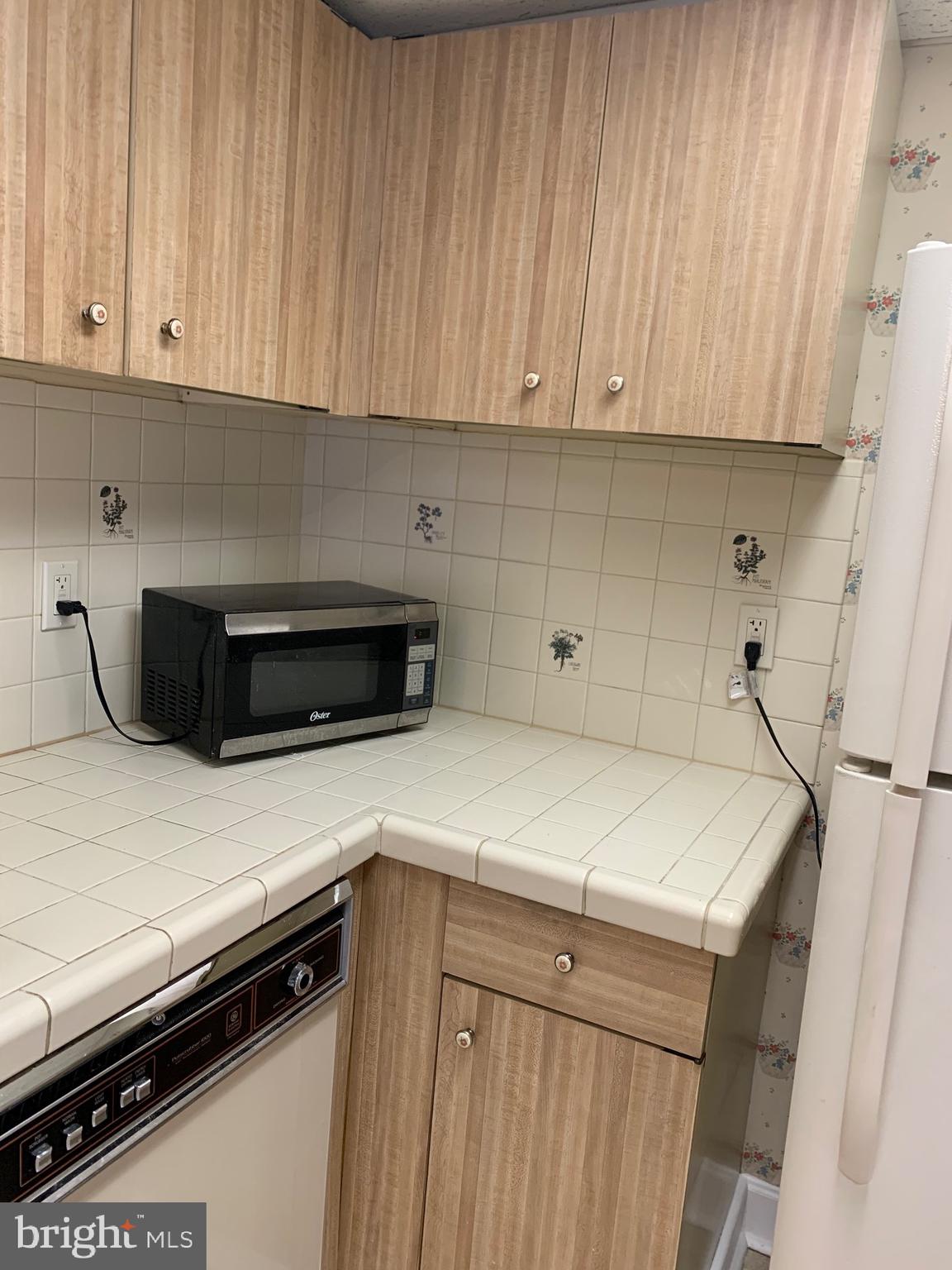 801 Yale Avenue, Unit 207 Swarthmore, PA 19081 - Photo 15 of 35 a kitchen with a sink and cabinets