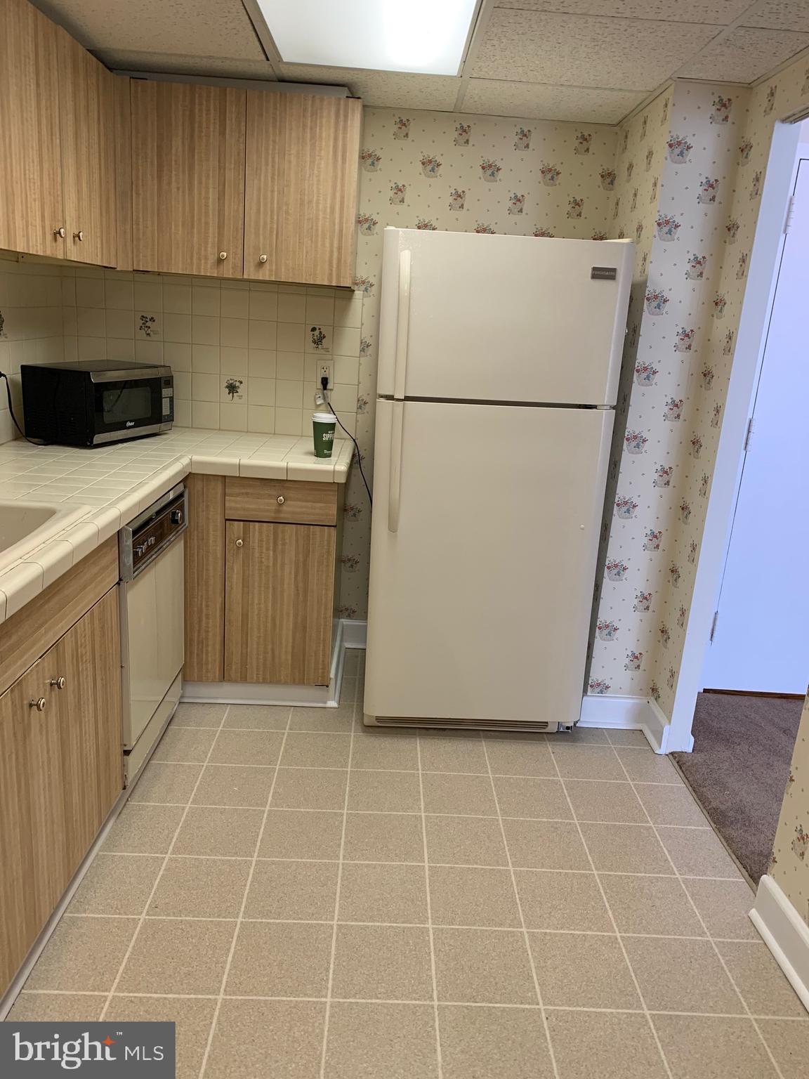 801 Yale Avenue, Unit 207 Swarthmore, PA 19081 - Photo 16 of 35 a utility room with cabinets washer and dryer