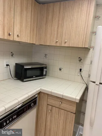 a utility room with cabinets washer and dryer