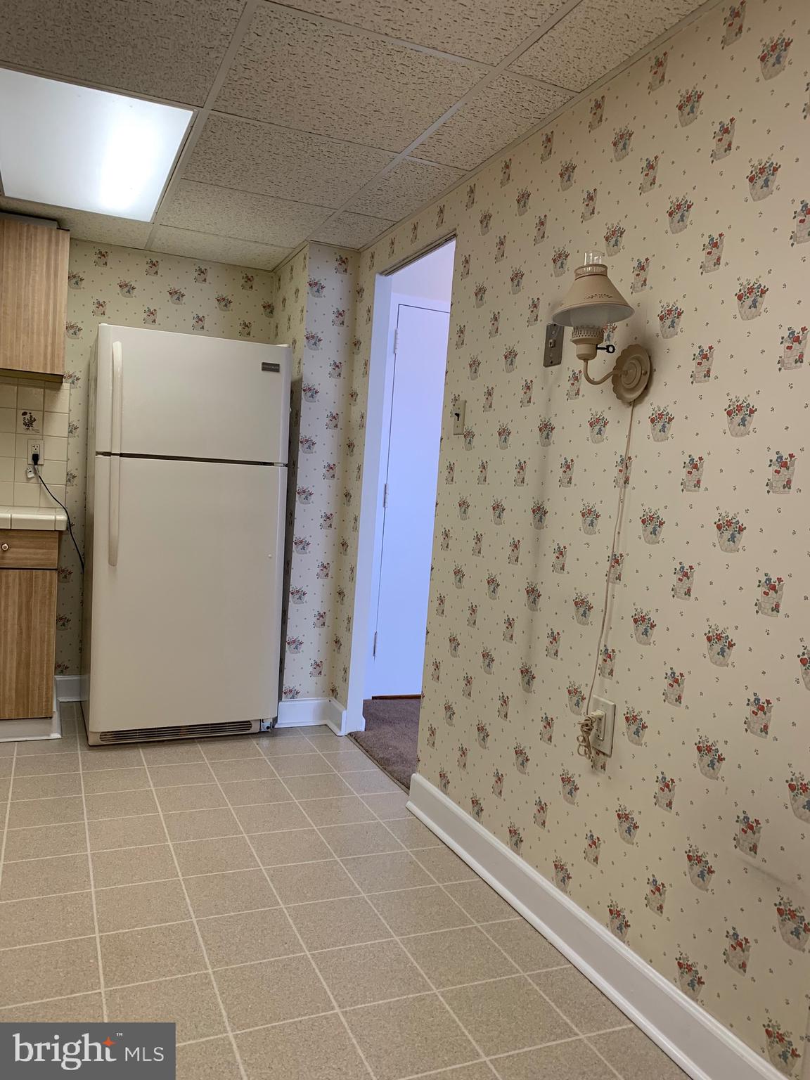 801 Yale Avenue, Unit 207 Swarthmore, PA 19081 - Photo 20 of 35 a view of a refrigerator in kitchen and an empty room