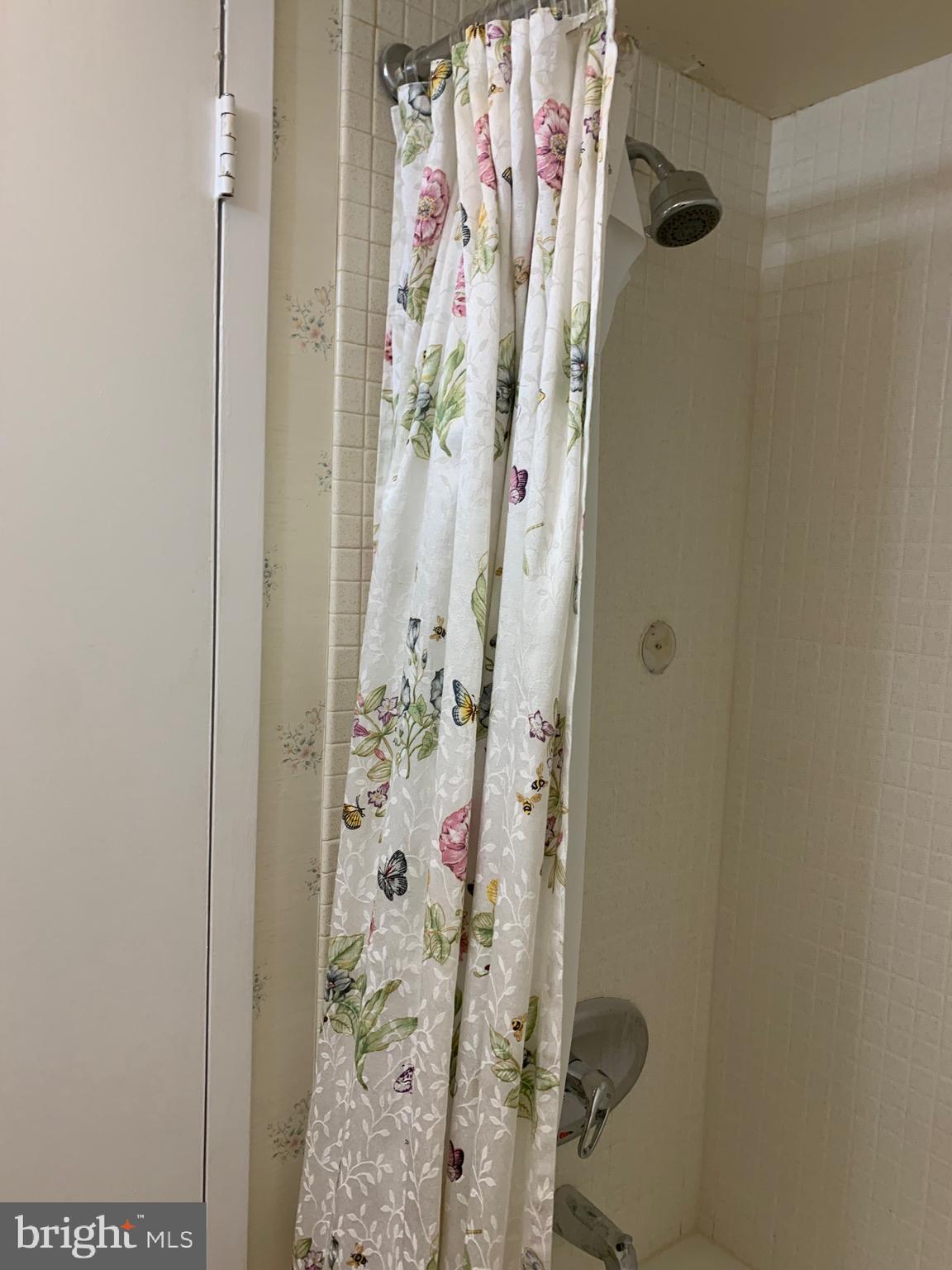 801 Yale Avenue, Unit 207 Swarthmore, PA 19081 - Photo 26 of 35 a bathroom with a shower curtain
