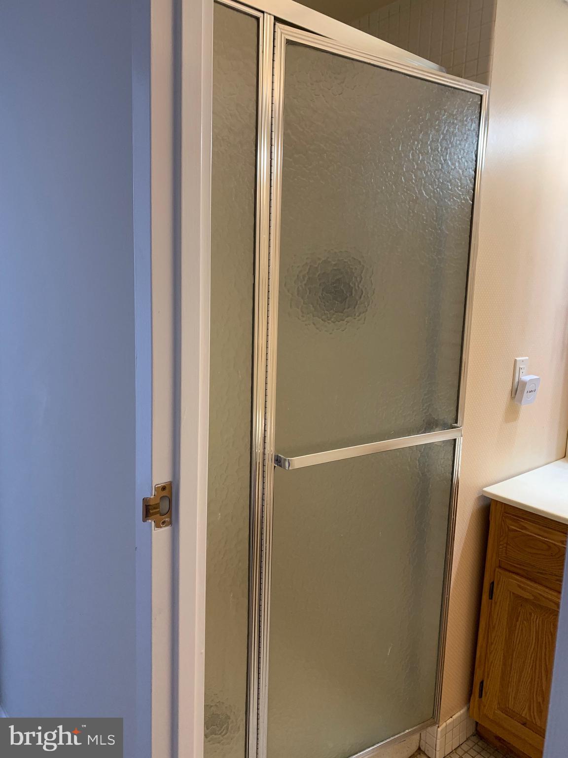 801 Yale Avenue, Unit 207 Swarthmore, PA 19081 - Photo 29 of 35 a bathroom with a glass shower door