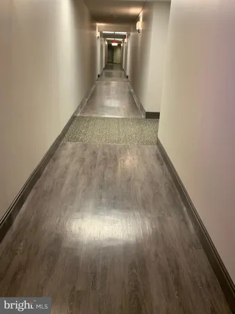a view of a hallway view with wooden floor