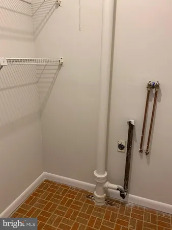 a bathroom with a window and a shower