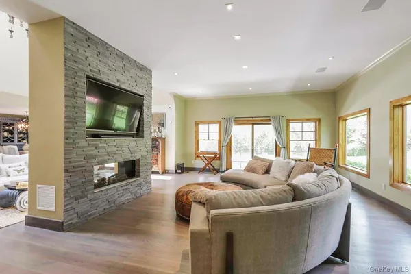 a living room with fireplace furniture and a flat screen tv