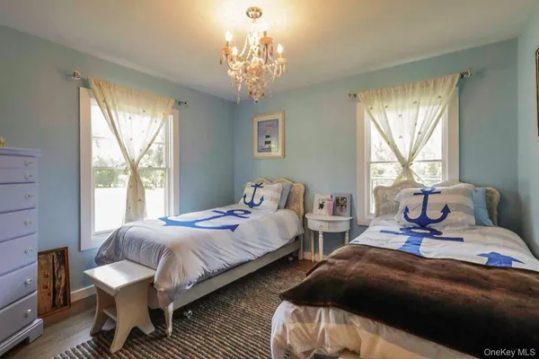 a bedroom with two beds and a window