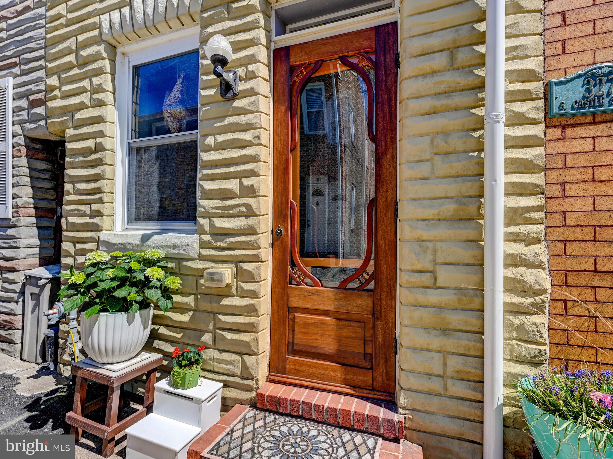 325 South Castle Street Baltimore, MD 21231 - Photo 1 of 31 a front view of a house with chairs and a potted plant