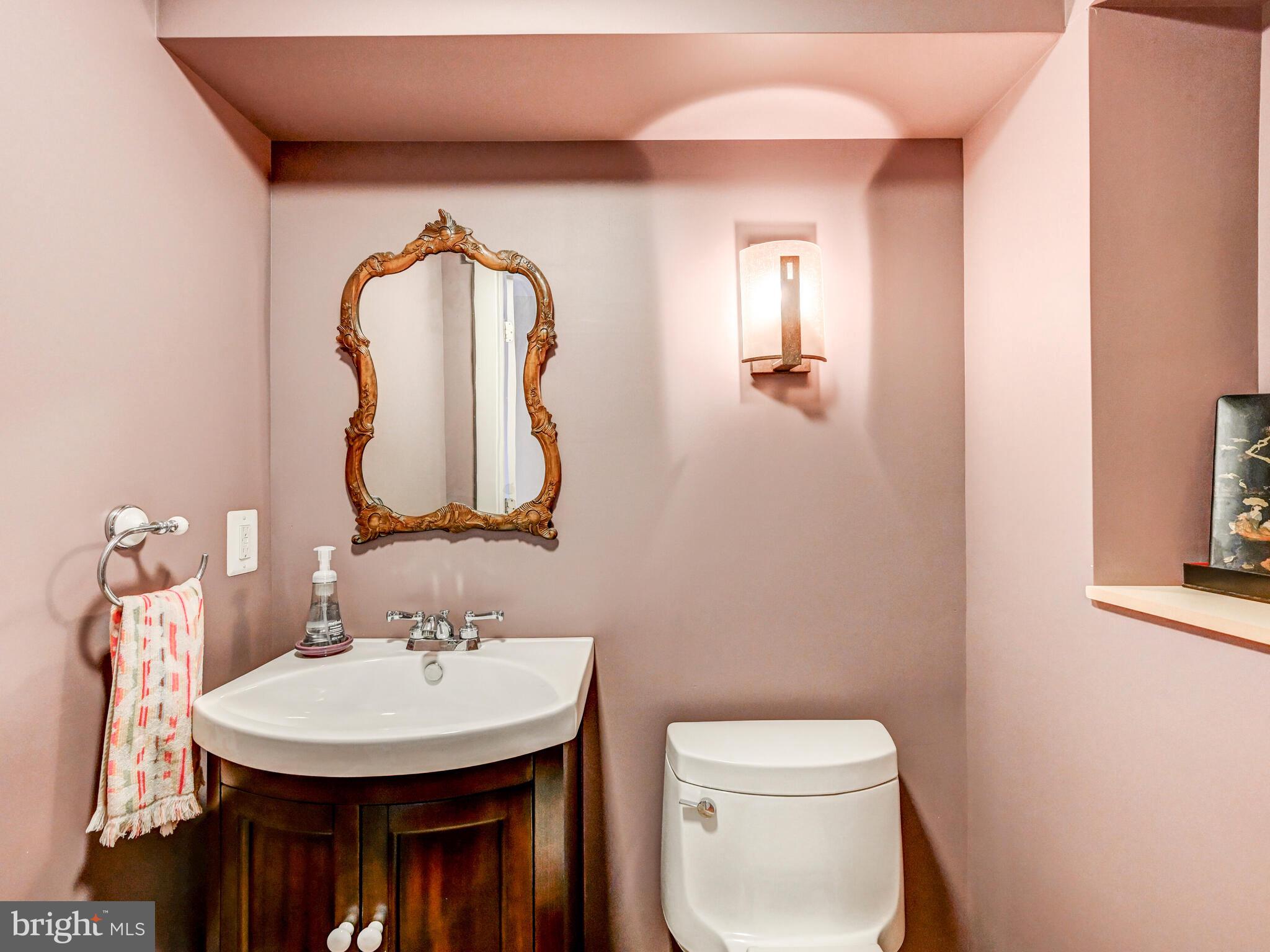325 South Castle Street Baltimore, MD 21231 - Photo 11 of 31 a bathroom with a toilet sink and mirror