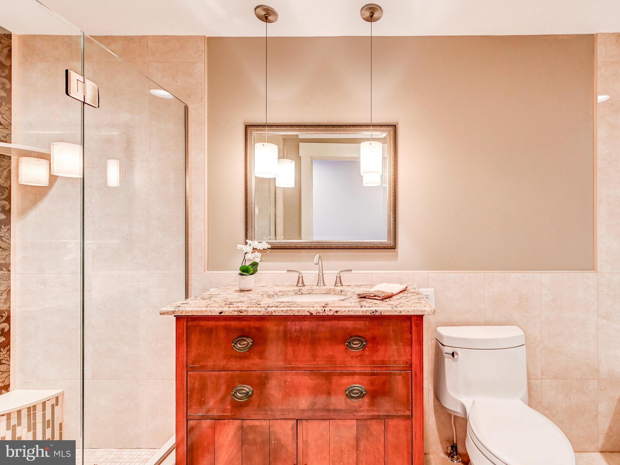 325 South Castle Street Baltimore, MD 21231 - Photo 13 of 31 a bathroom with a granite countertop sink mirror vanity and toilet