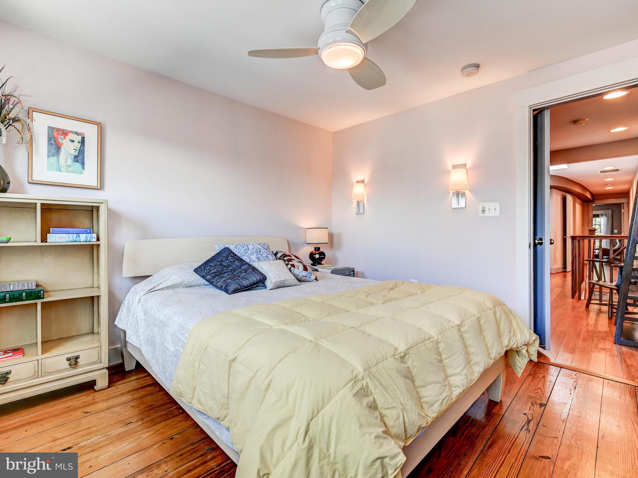 325 South Castle Street Baltimore, MD 21231 - Photo 23 of 31 a bedroom with bed and wooden floor