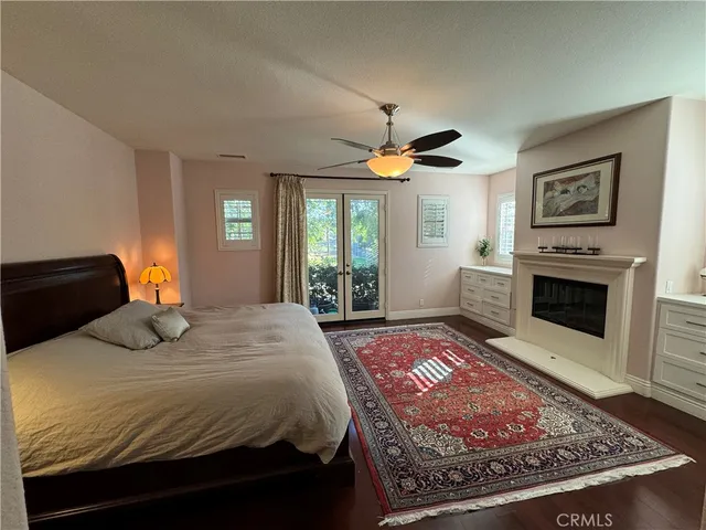 a bedroom with a large bed and a fireplace