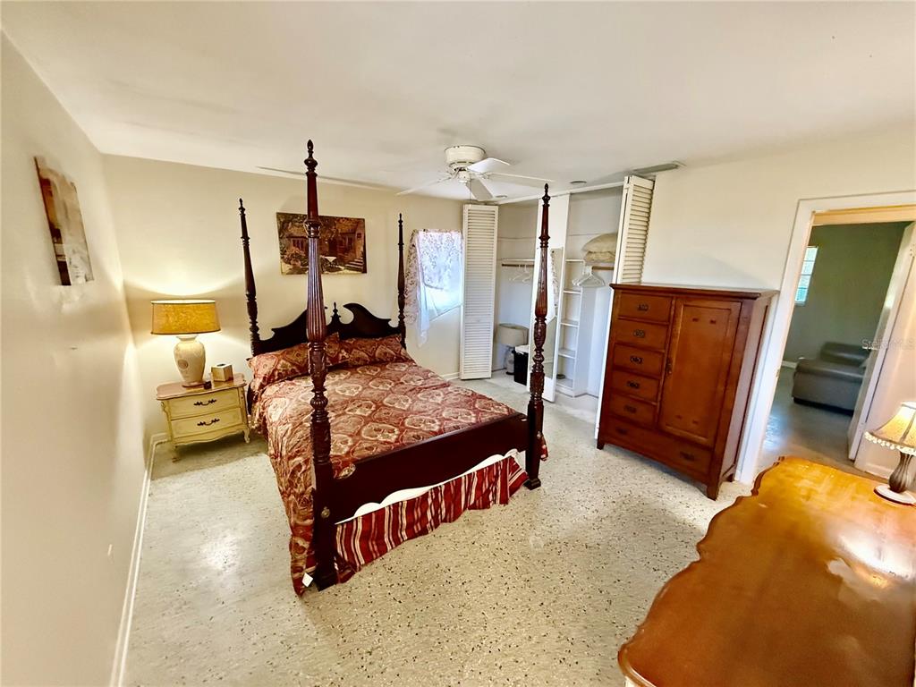 1004 Connecticut Road Tarpon Springs, FL 34689 - Photo 24 of 57 a bedroom with a bed and wooden floor
