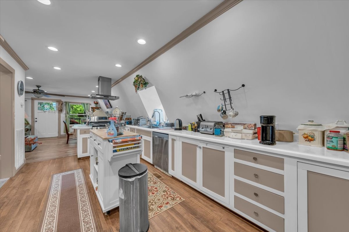 475 Lost Creek Road Lynchburg, TN 37352 - Photo 14 of 34 a kitchen with stainless steel appliances kitchen island granite countertop a lot of counter top space and wooden floor